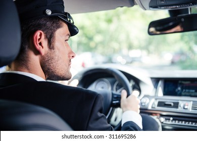 Portrait of a handsome male chauffeur riding car