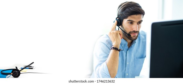 Portrait Of Handsome Male Customer Service In Headphones. Call Center Staff Speaking With Head Set In Modern Office