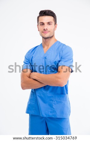 Portrait of a handsome male doctor standing with arms folded isolated on a white background. Lookign at camera