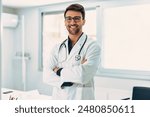 Portrait of handsome male doctor with stethoscope over neck working while looking at camera in the medical consultation.