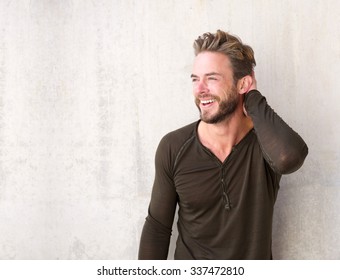 Portrait Of A Handsome Man With Beard Laughing With Hand In Hair