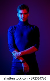 Portrait Of A Handsome Man With Bristle In Blue And Red Light. Male Beauty, Fashion.