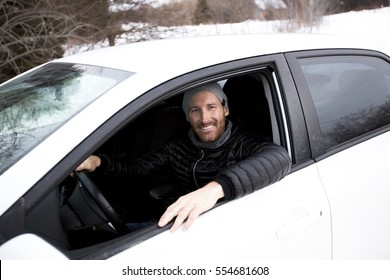 A Portrait Of Handsome Man In Car In Winter