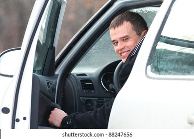 Portrait Of Handsome Man In Car In Winter