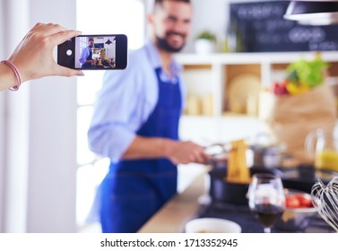 Portrait of handsome man filming cooking show or blog - Shutterstock ID 1713352945