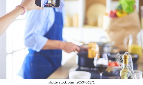 Portrait Of Handsome Man Filming Cooking Show Or Blog