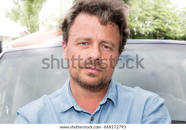 portrait handsome\
man in front of car\
outdoors