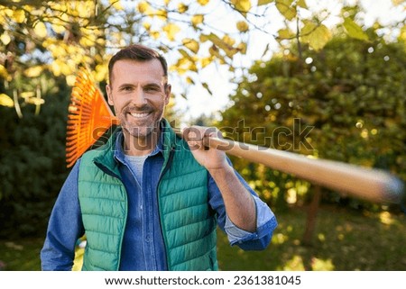 Similar – Image, Stock Photo Male gardener raking the the flower bed while the collegue is sweeping the terrace in summer