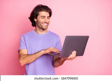 Portrait Of Handsome Man Look Use Netbook Positive Programmer Wear Violet Isolated On Pink Color Background