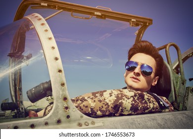 Portrait Of A Handsome Man Pilot Wearing Sunglasses In Cockpit Of Fighter Jet. Military Aircraft.