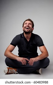 Portrait Of Handsome Man Sitting With Crossed Legs