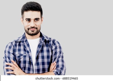 Portrait of handsome man smiling with copy space on gray background