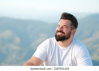 Portrait of a handsome man smiling outdoor.