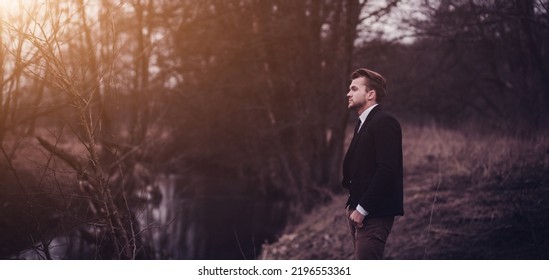 Portrait Handsome Man In Suit In The Autumn Park