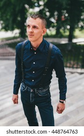 Portrait Of Handsome Man With Suspenders Outdoors