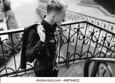 Portrait Of Handsome Man With Suspenders Outdoors