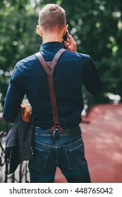 Portrait Of Handsome Man With Suspenders Outdoors