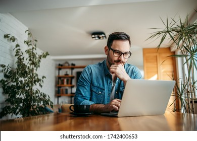 Portrait of a handsome man using laptop at home. - Shutterstock ID 1742400653
