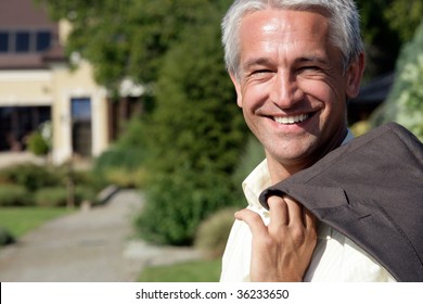 Portrait of handsome mature businessman smiling