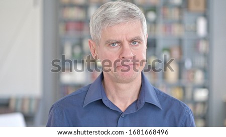 Portrait of Handsome Middle Aged Man saying No by Shaking Head