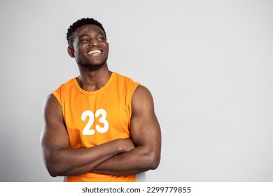 Portrait of handsome muscular African man, smiling basketball player with arms crossed looking away, isolated on white background, copy space. Sport concept   - Powered by Shutterstock