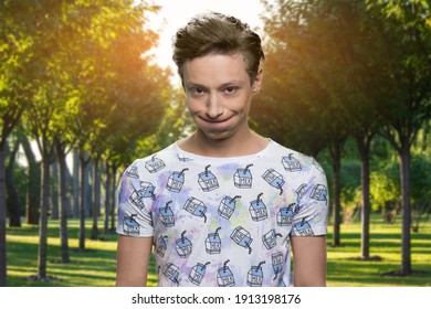 Portrait Of Handsome Offended Teen Boy In The Park. Dissapointed Young Guy. Mouth Filled With Air.