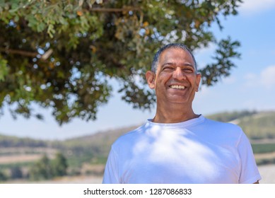 Portrait Of Handsome Old Active Senior Man Outdoors. Mature Male With Kind Eyes And Beautiful Smile.Sporty Athletic Elderly Businessman On Nature Background.  