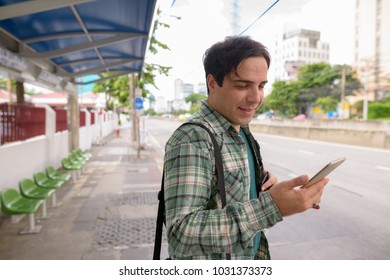 Portrait of handsome Persian tourist man exploring the city of Bangkok, Thailand