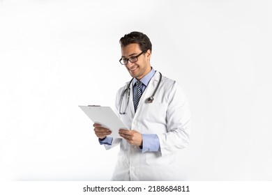 Portrait of handsome positive doctor in medical gown and stethoscope holding tablet and smiling isolated on white background - Powered by Shutterstock