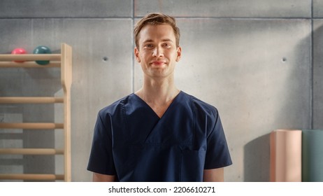 Portrait of a Handsome Professional Male Nurse in Uniform Standing and Posing for Camera, Smiling in Medical Rehabilitation Center. Physiotherapy Assistant In Hospital. Young Practising Doctor. - Powered by Shutterstock