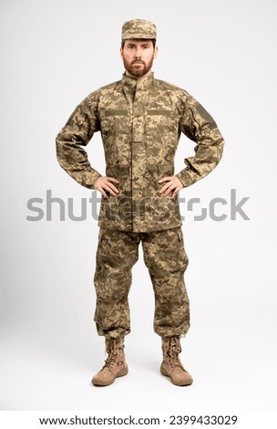 Portrait handsome professional soldier wearing camouflage military uniform looking at camera isolated on white background