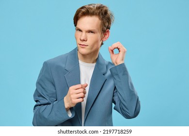 Portrait Of A Handsome Redhead Guy Showing A Funny Sign With His Hand