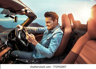 Portrait Of A Handsome, Rich Guy Driving His Convertible Car