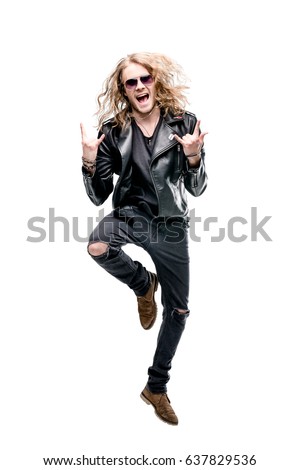 portrait of handsome rocker in black leather jacket and sunglasses showing rock signs isolated on white, rock star concept
