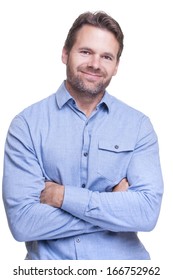 Portrait Of Handsome Rugged Bearded Caucasian Man With Folded Arms Smiling On White Background