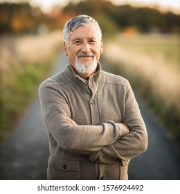 Portrait of handsome senior man in the autumn outdoors. Active senioor enjoying his retirement in the  nature - Powered by Shutterstock