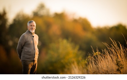 Portrait of handsome senior man in the autumn outdoors. Active senioor enjoying his retirement in the  nature - Powered by Shutterstock