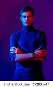 Portrait Of A Handsome Serious Man In Blue And Red Light. Male Beauty, Fashion.