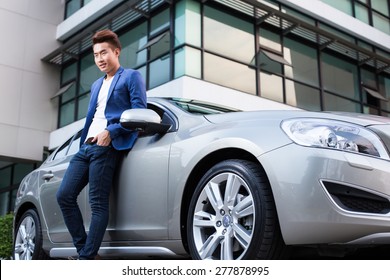 Portrait Of An Handsome Smiling Asian Business Man With His Car And White Shirt And Blue Coat