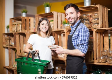 Portrait Of A Handsome Store Clerk Giving Some Assistance To A Customer At The Supermarket