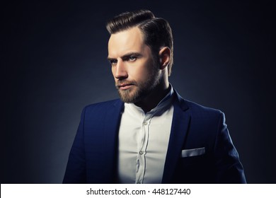 Portrait Of Handsome Stylish Caucasian Young Man In Elegant Blue Suit With Perfect Hair Style. Toned