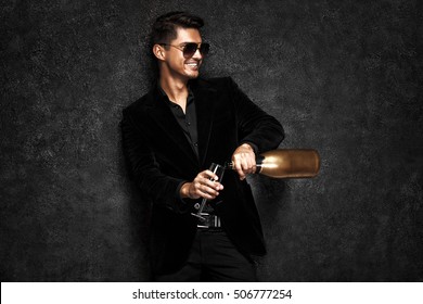 Portrait of handsome stylish man in elegant black suit. Luxury boy.