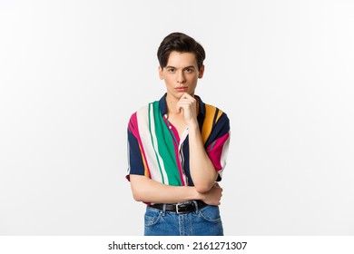 Portrait of handsome and stylish man looking thoughtful at camera, making choice, thinking at staring at you, standing over white background - Powered by Shutterstock