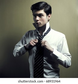 Portrait Of A Handsome Stylish Young Man Tie A Tie