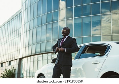 Portrait Of A Handsome Successful African American Businessman In A Suit Near His Luxury Car