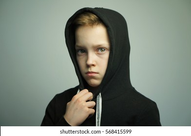 Portrait Of A Handsome Teenage Bad Boy With Slingshot And Stylish Haircut, Softbox Lighting Studio Shot.