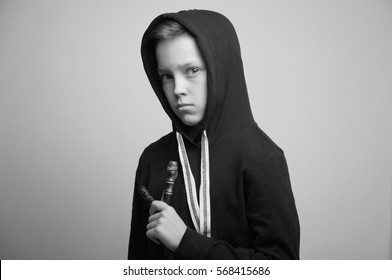 Portrait Of A Handsome Teenage Bad Boy With Slingshot And Stylish Haircut, Softbox Lighting Studio Shot.