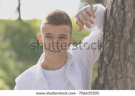 Similar – Image, Stock Photo Stylish teenager sitting on a wooden bench