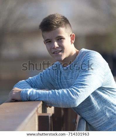 Similar – Image, Stock Photo Stylish teenager sitting on a wooden bench