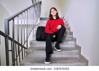 Portrait Of A Handsome Teenage Male 17, 18 Years Old Sitting On The Stairs